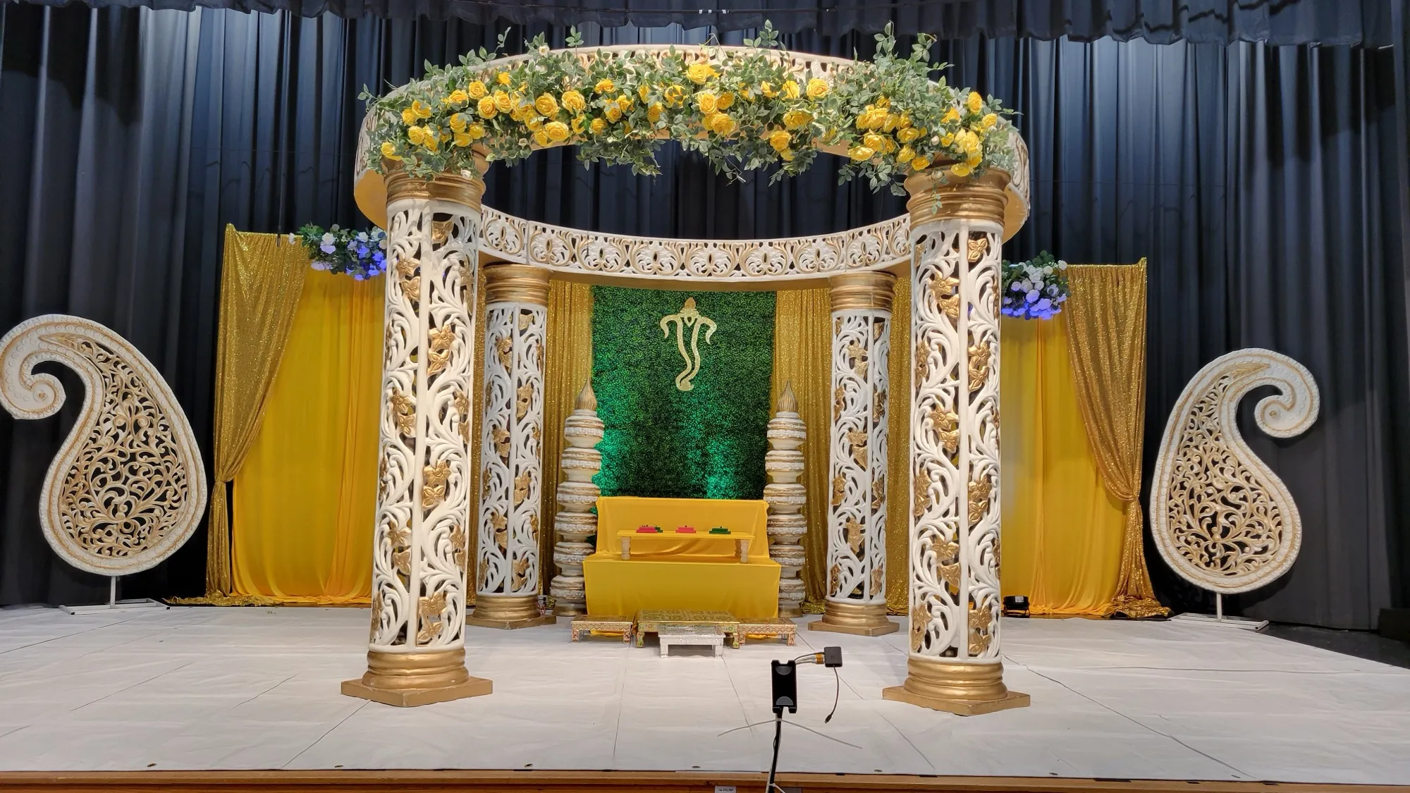 Mandap front view green backdrop — Yellow & Gold Mandap with Paisley Pillars