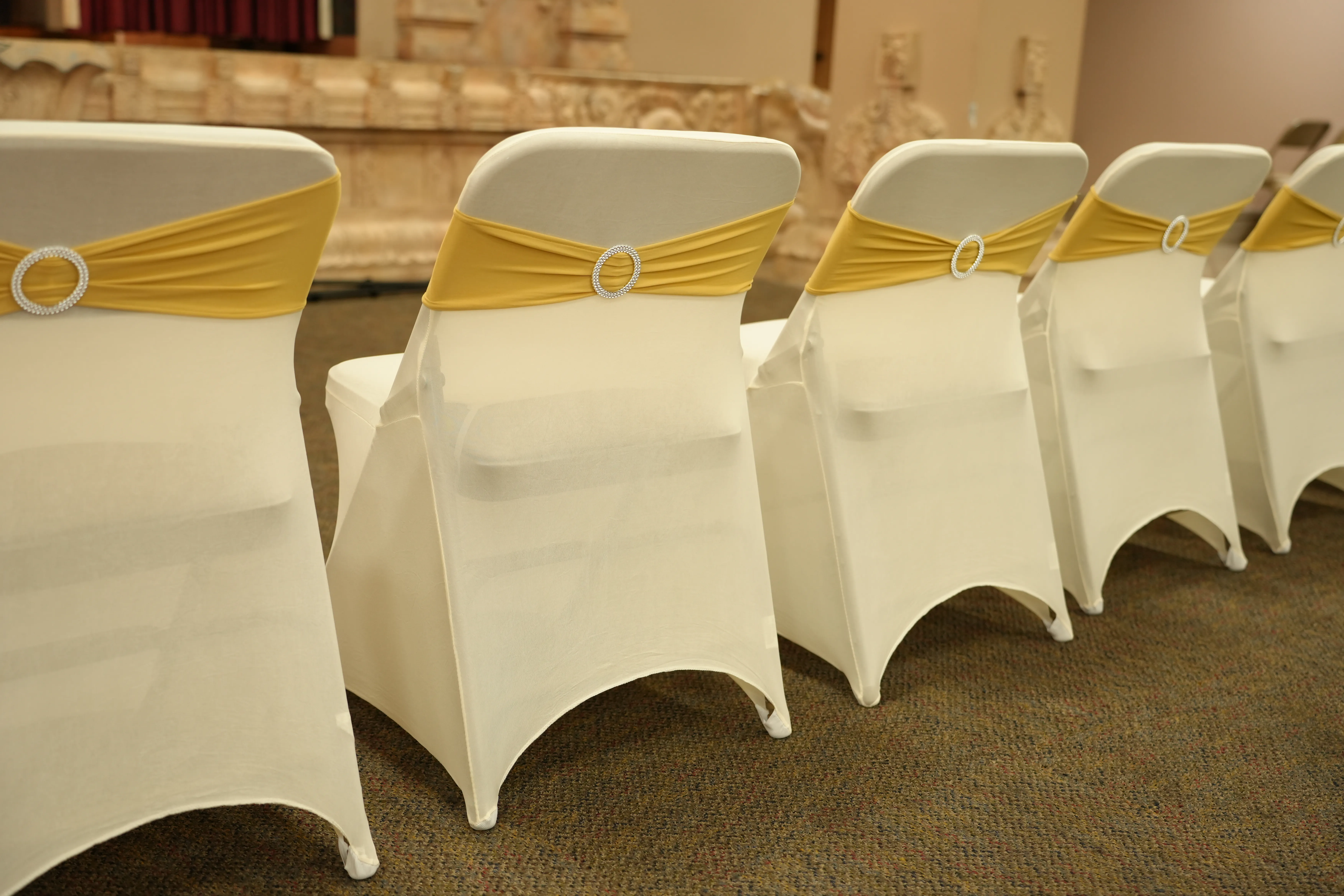 Chair cover gold sash detail — White & Gold Carved Mandap