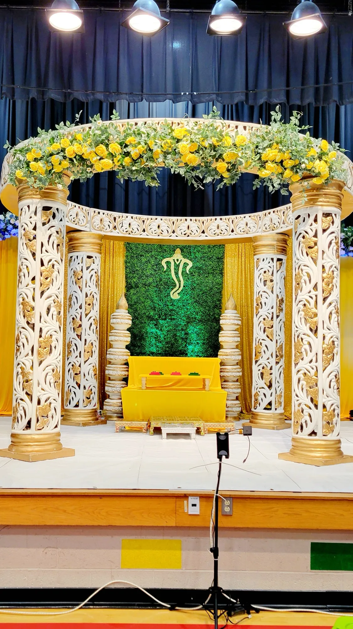 Mandap detail arch yellow flowers — Yellow & Gold Mandap with Paisley Pillars
